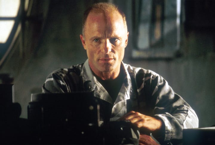 What director did Ed Harris allegedly punch in the face?